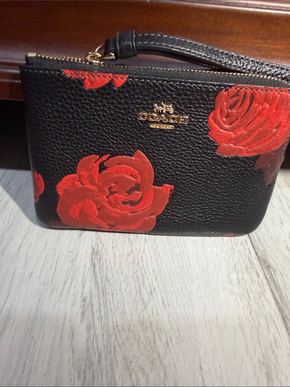 COACH Black Pebbled Leather Wristlet with Red Rose Print